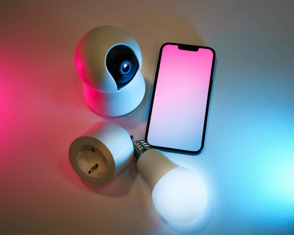 A smart phone sitting on top of a table next to a flashlight
